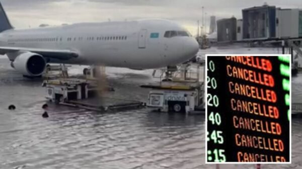 "Flooding around an airplane on the tarmac with a flight information board showing cancellations